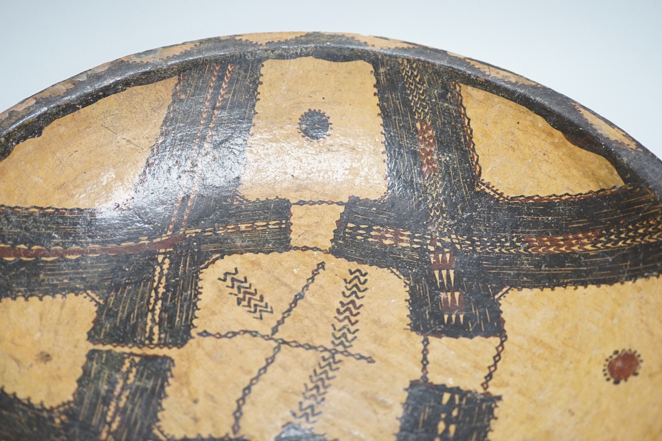 A Berber Kabyle painted clay dish with geometric stitching design, 42.5cm